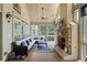 Relaxing sunroom with a fireplace, wood floors, large windows, and plenty of seating at 8170 Hurakan Creek Xing, Cumming, GA 30028