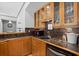 Charming wet bar featuring custom wood cabinets, granite counters, and a convenient beverage cooler at 8170 Hurakan Creek Xing, Cumming, GA 30028