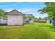 View of the home's spacious backyard with lush green grass, partial deck, and classic home elevation at 892 Wayland Ct, Smyrna, GA 30080