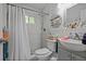 Bathroom featuring tiled shower, toilet, and single sink vanity with storage at 892 Wayland Ct, Smyrna, GA 30080