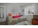 Bedroom with neutral wall color, bright windows, and patterned bedspread at 892 Wayland Ct, Smyrna, GA 30080