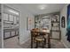 Dining room with wooden table set and built in shelving for displaying decorations, adjoining kitchen at 892 Wayland Ct, Smyrna, GA 30080