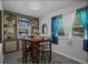 Dining area with a wooden table set, modern bar stools, and stylish curtains for a cozy atmosphere at 892 Wayland Ct, Smyrna, GA 30080