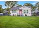 Charming home featuring a well-manicured lawn, complemented by decorative accents and a pink front door at 892 Wayland Ct, Smyrna, GA 30080