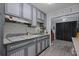 Kitchen with modern two-toned cabinets, subway tile backsplash, and access to dining area at 892 Wayland Ct, Smyrna, GA 30080