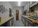 Galley kitchen with modern cabinetry, white backsplash and sleek countertops for meal preparation at 892 Wayland Ct, Smyrna, GA 30080