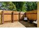 This backyard has a patio, wooden fence and comfortable outdoor seating surrounded by lush green trees at 111 Northdale Pl, Lawrenceville, GA 30046