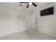 Carpeted bedroom with ceiling fan, mounted TV, and two large closets at 111 Northdale Pl, Lawrenceville, GA 30046