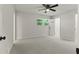 Large primary bedroom featuring new gray carpet, ceiling fan, and a window at 111 Northdale Pl, Lawrenceville, GA 30046