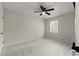 This bedroom has neutral walls, carpet, ceiling fan and a bright window with a view of the outdoors at 111 Northdale Pl, Lawrenceville, GA 30046