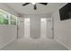 Bedroom with new gray carpet, ceiling fan, window, and dual closets at 111 Northdale Pl, Lawrenceville, GA 30046