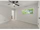 This bedroom has neutral walls, carpet, ceiling fan and a bright window with a view of the outdoors at 111 Northdale Pl, Lawrenceville, GA 30046