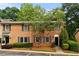Charming brick townhouse with well-maintained landscaping and dark shutters at 111 Northdale Pl, Lawrenceville, GA 30046