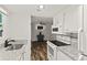 Bright kitchen with granite countertops, modern appliances, and open layout to living area at 111 Northdale Pl, Lawrenceville, GA 30046