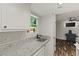 Stylish kitchen with granite countertops and black faucet overlooking the open living area at 111 Northdale Pl, Lawrenceville, GA 30046