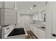 Galley kitchen featuring white appliances, granite countertops, and wood laminate flooring for added style at 111 Northdale Pl, Lawrenceville, GA 30046