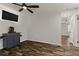 Well-lit living room featuring wood laminate flooring, ceiling fan, and access to additional rooms at 111 Northdale Pl, Lawrenceville, GA 30046