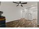 Open-concept living room and kitchen with white appliances and wood floors at 111 Northdale Pl, Lawrenceville, GA 30046