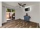 Cozy living room with ceiling fan, wood laminate flooring, and view of the private outdoor patio at 111 Northdale Pl, Lawrenceville, GA 30046