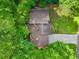 Aerial view of a home with a brown roof, surrounded by lush green trees at 162 Riverchase Dr, Woodstock, GA 30188