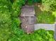 An aerial view of the home showing mature trees surrounding the property at 162 Riverchase Dr, Woodstock, GA 30188