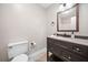 The bathroom features a dark vanity with granite countertop and tile flooring at 162 Riverchase Dr, Woodstock, GA 30188