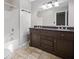 Bathroom with double sink vanity, bath tub and neutral tiling at 162 Riverchase Dr, Woodstock, GA 30188