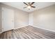 Bedroom features a ceiling fan, wood-look flooring, and two closets at 162 Riverchase Dr, Woodstock, GA 30188