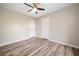 Bedroom features a ceiling fan, wood-look flooring, and two closets at 162 Riverchase Dr, Woodstock, GA 30188