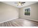 Bright bedroom with hardwood floors, ceiling fan, and natural light from the window at 162 Riverchase Dr, Woodstock, GA 30188