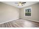 Bedroom features a ceiling fan, a window, and wood-look flooring at 162 Riverchase Dr, Woodstock, GA 30188