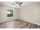 Bedroom features a ceiling fan, a window, and wood-look flooring at 162 Riverchase Dr, Woodstock, GA 30188