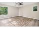Bright bedroom with wood floors, ceiling fan, and large windows at 162 Riverchase Dr, Woodstock, GA 30188
