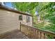 Home exterior featuring wood deck overlooking a wooded lot at 162 Riverchase Dr, Woodstock, GA 30188