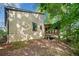 Exterior side view of home with a porch and wooded lot at 162 Riverchase Dr, Woodstock, GA 30188
