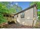 Exterior side view of home with a porch and wooded lot at 162 Riverchase Dr, Woodstock, GA 30188