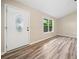 Bright foyer showcasing wood-look flooring, a modern front door, and a window with natural light at 162 Riverchase Dr, Woodstock, GA 30188