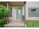 Inviting front door with decorative glass, complemented by stylish shutters and manicured greenery at 162 Riverchase Dr, Woodstock, GA 30188