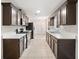 Well-lit kitchen with brown cabinets, stainless steel appliances, and tile flooring at 162 Riverchase Dr, Woodstock, GA 30188