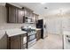 Modern kitchen featuring stainless steel appliances, tile floors, and lots of cabinet space at 162 Riverchase Dr, Woodstock, GA 30188