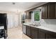 Kitchen with brown cabinets, stainless steel appliances, tile floors, and a bright window at 162 Riverchase Dr, Woodstock, GA 30188