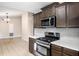 A kitchen featuring dark cabinets, stainless appliances, white counter tops and tile floors at 162 Riverchase Dr, Woodstock, GA 30188
