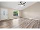 Bright living room featuring wood-look flooring, a vaulted ceiling, and a window with natural light at 162 Riverchase Dr, Woodstock, GA 30188