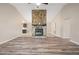 Spacious living room with new flooring, a stone fireplace, and an open layout for entertaining at 162 Riverchase Dr, Woodstock, GA 30188