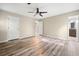 Spacious main bedroom with wood floors, ceiling fan, and ensuite bath at 162 Riverchase Dr, Woodstock, GA 30188