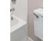Toilet and tub and shower combo with white tiling at 162 Riverchase Dr, Woodstock, GA 30188