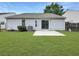 Backyard with green lawn, a concrete patio, and siding of the home at 2628 Downingwood Ln, Grayson, GA 30017