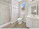 Bright bathroom with a glass-enclosed shower, white cabinets, and modern fixtures at 2628 Downingwood Ln, Grayson, GA 30017