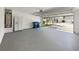 Open two-car garage featuring epoxy floor and appliances, offering ample parking and storage at 2628 Downingwood Ln, Grayson, GA 30017