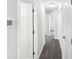 Hallway with neutral paint, plush carpet flooring and white doors at 2628 Downingwood Ln, Grayson, GA 30017